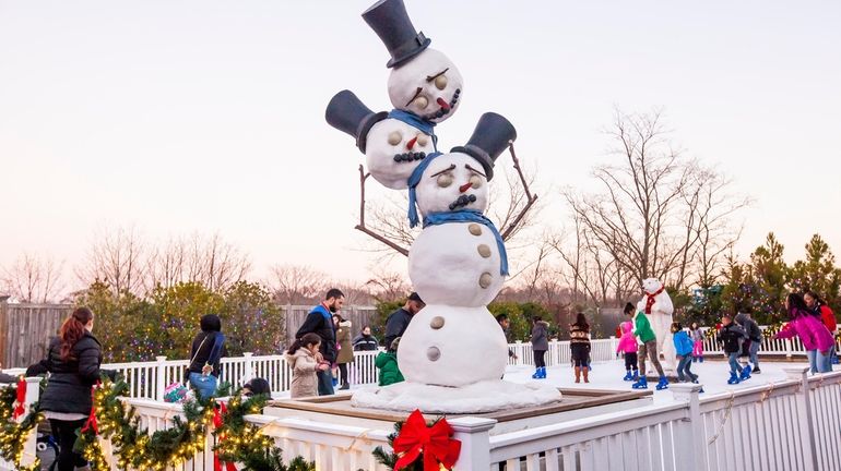 Snowman stands at the ice skating rink at the Bayville...