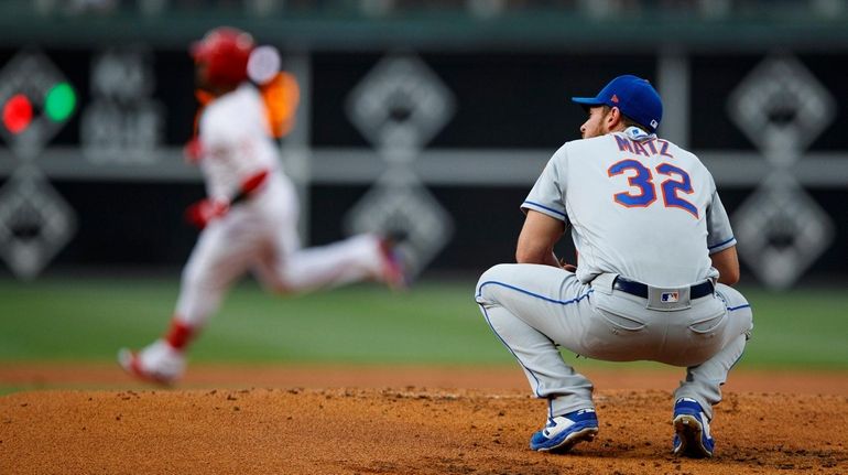 Mets starting pitcher Steven Matz, right, reacts after giving up...