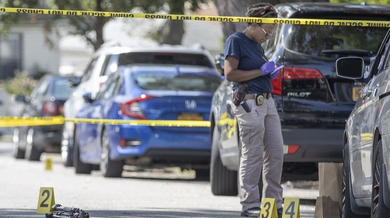 An NYPD Crime Scene Unit detective gathers and logs evidence...