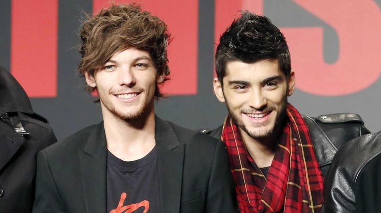 One Direction members Louis Tomlinson, left, and Zayn Malik during...