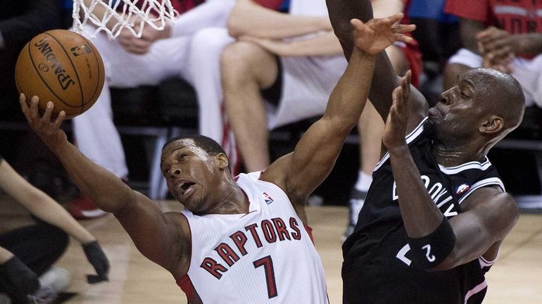 Toronto Raptors guard Kyle Lowry (7) gets fouled by Kevin...