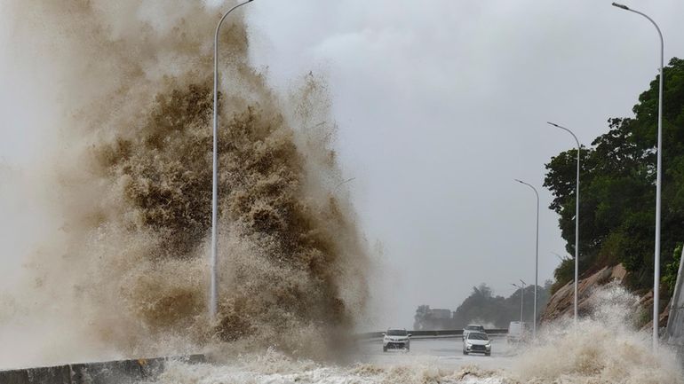 In this photo released by Xinhua News Agency, huge waves...