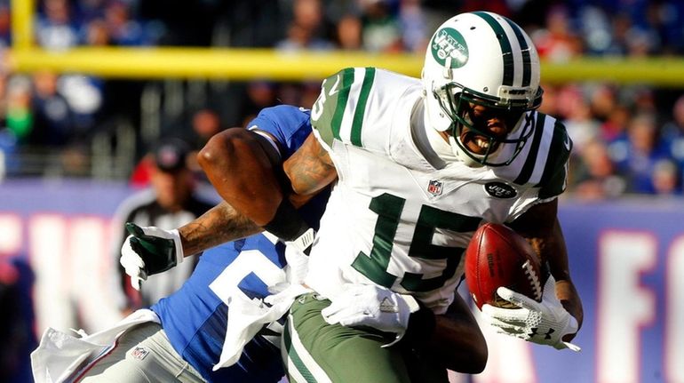 Brandon Marshall #15 of the New York Jets runs the...