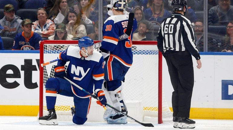 Adam Pelech #3 and Ilya Sorokin #30 of the Islanders look...