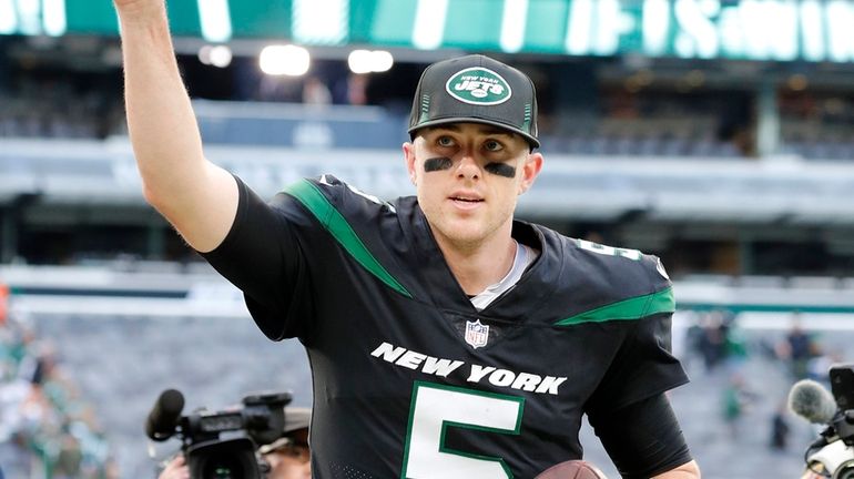 Mike White of the New York Jets runs off the field...