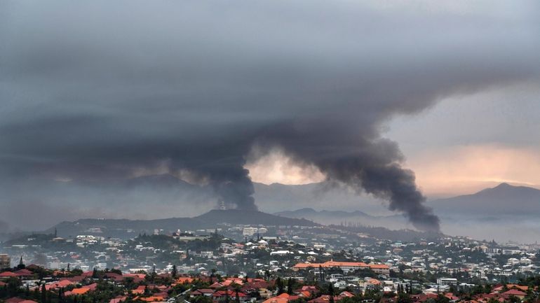 Smoke rises during protests in Noumea, New Caledonia, Wednesday May...