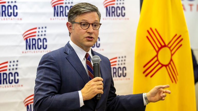 House Speaker Mike Johnson talks to attendees of a campaign...