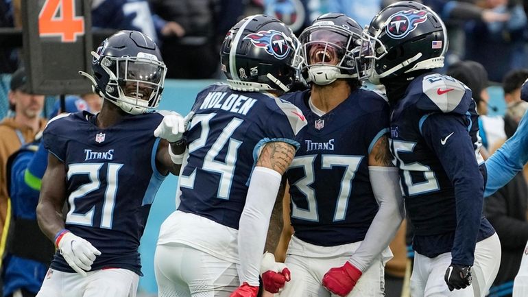 Tennessee Titans safety Amani Hooker (37) celebrates with cornerback Elijah...