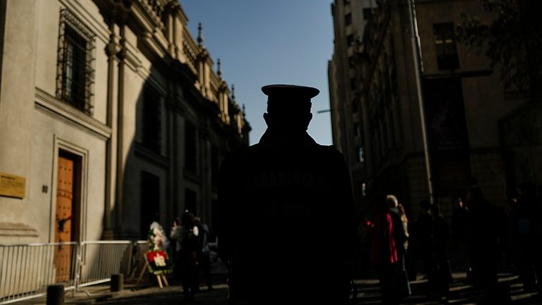 A police officer stands guard by the eastern entrance of...