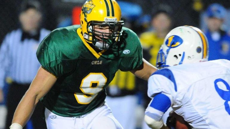 Lynbrook High School #9 Mike Kozlakowski, left, closes in on...