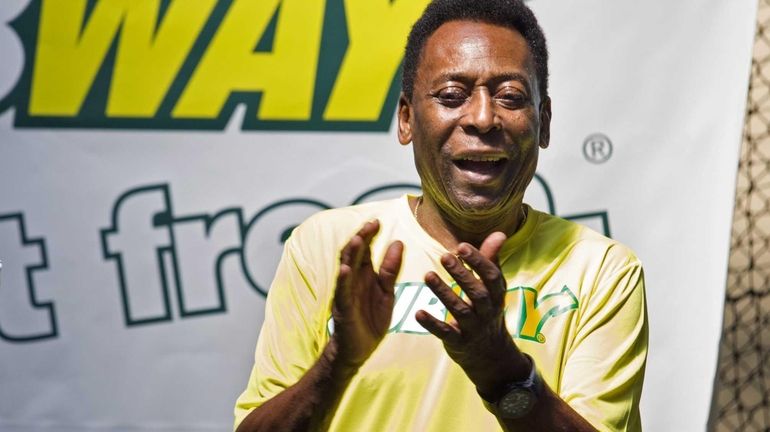 International soccer legend Pele cheers children during a soccer clinic...