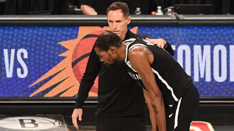 Nets head coach Steve Nash consoles Kevin Durant as the...