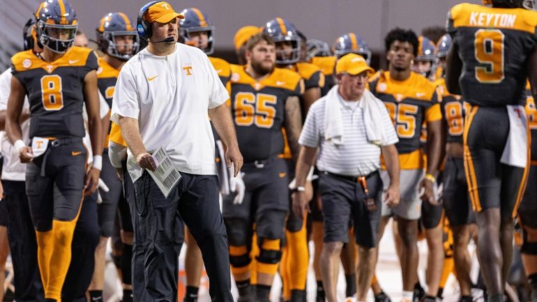 Tennessee head coach Josh Heupel, front left, watches play during...