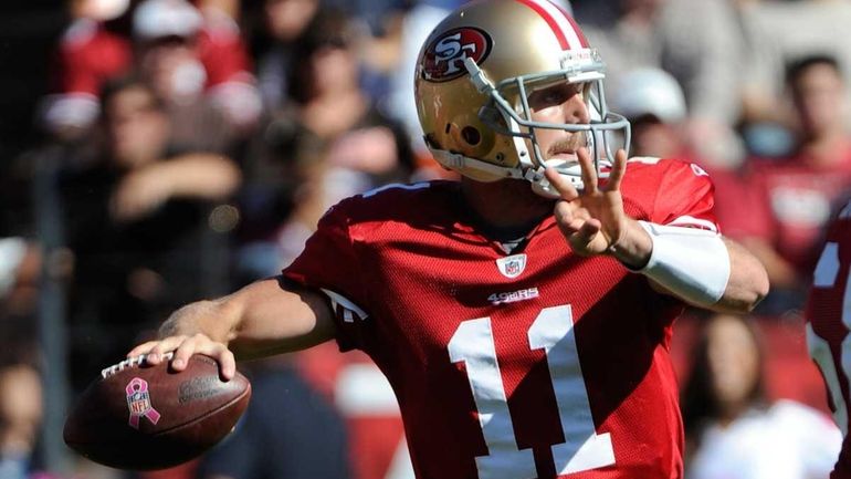 Alex Smith of the San Francisco 49ers drops back to...