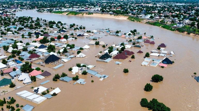 Houses and buildings are partially submerged following a dam collapse...