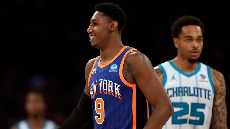 Knicks guard RJ Barrett reacts in front of Hornets forward P.J....