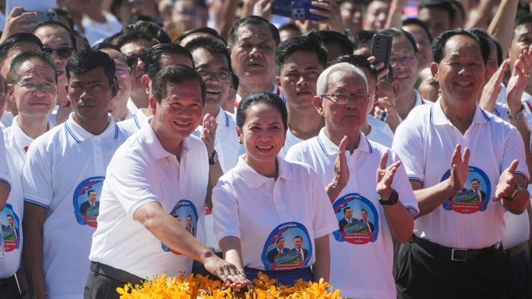 Cambodian Prime Minister Hun Manet, front left, accompanied by his...