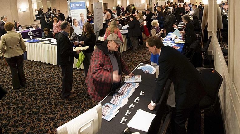 Job seekers explore their options during Job Fair 2014 at...