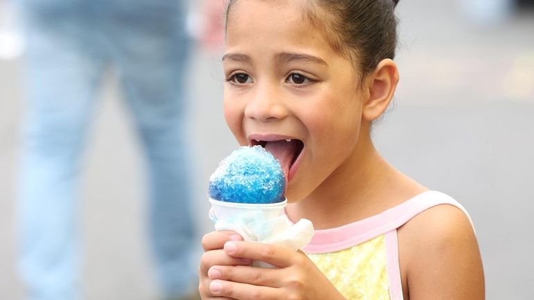 Ava Rojas, 7, of Central Islip, enjoys an ice cone...