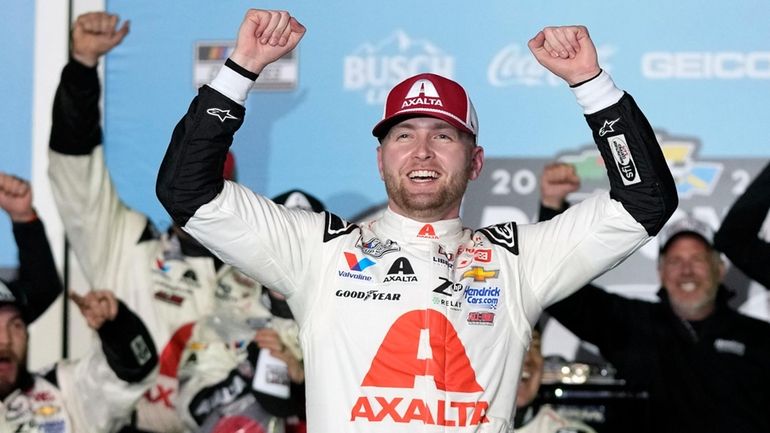 William Byron celebrates in Victory Lane after winning the NASCAR...