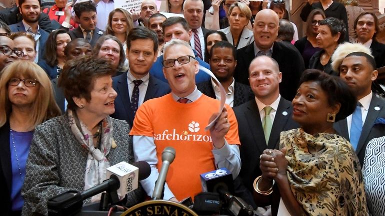 Michael Polenberg, center, vice president of Safe Horizon, spoke in favor...