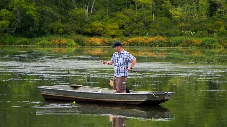 Fisherman on the lake at Suffolk County Blydenburgh Park was...