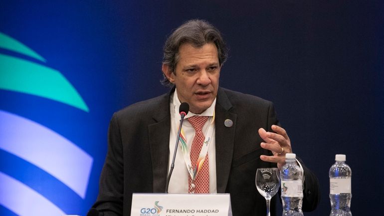 Brazilian Economy Minister Fernando Haddad attends a press conference to...