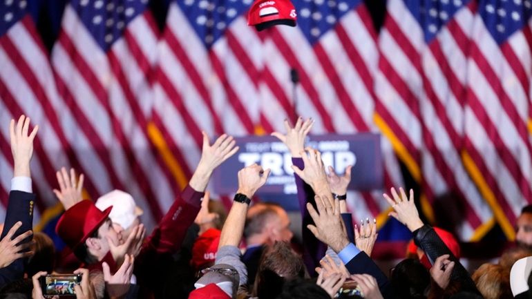 Supporters cheer after learning that Republican presidential candidate former President...