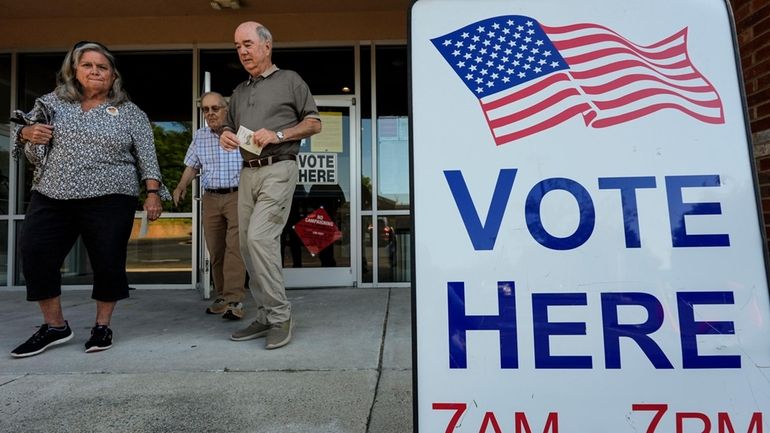 Voters depart an election center during primary voting, Tuesday, May...