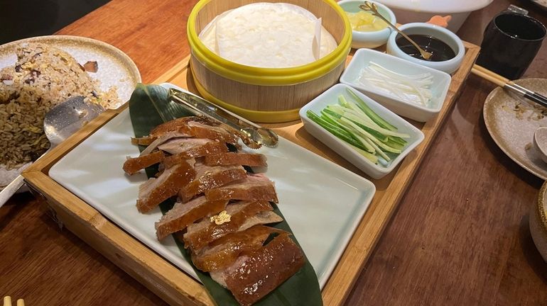 A half order of Peking Duck is presented with sugar...