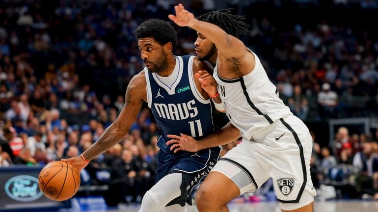 Dallas Mavericks guard Kyrie Irving (11) drives to the basket...