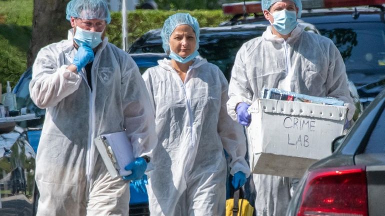 Police investigators search the Massapequa Park home of Rex Heuermann on July...