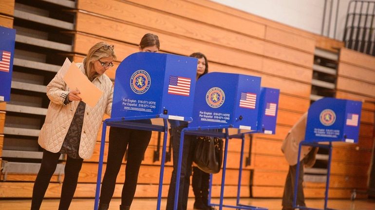 People vote on Election Day inside the Wheatley School in...