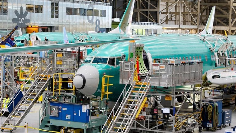 Boeing 737 MAX airplanes are shown on the assembly line...