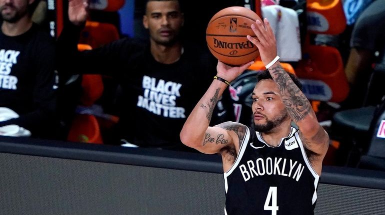 Nets' Chris Chiozza (4) shoots against the Sacramento Kings during...