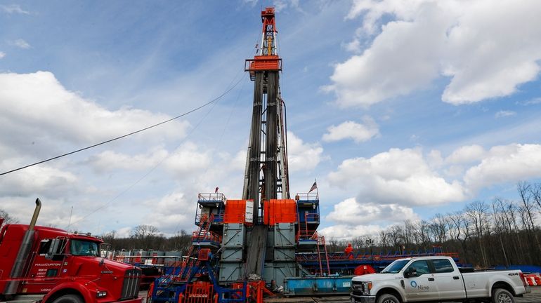 Work continues at a shale gas well drilling site in...