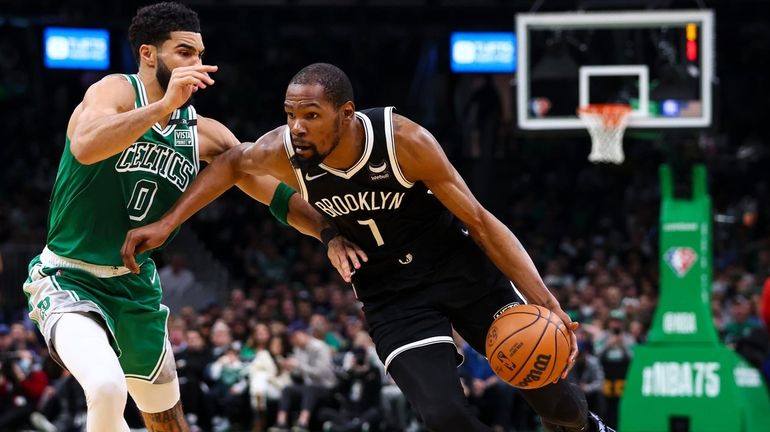 Kevin Durant #7 of the Nets drives to the basket...