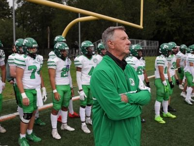 Farmingdale High School football coach Buddy Krumenacker and members of...