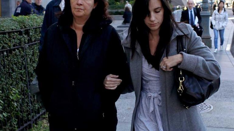 Maria Rusin, left, walks with her daughter from the Federal...