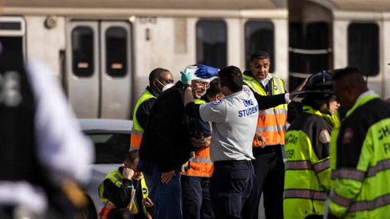 Chicago Fire Department and Chicago Police Department personnel triage patients...