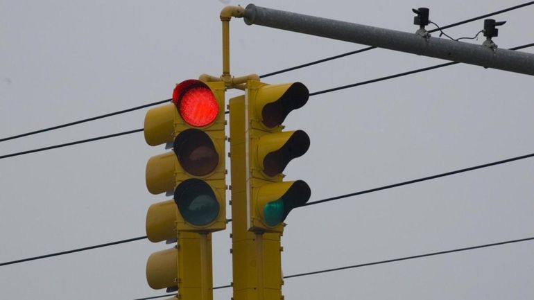 A red light is monitored by camera, located at Merrick...