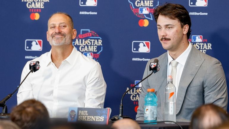 Arizona Diamondbacks and National League manager Torey Lovullo, left, smiles...