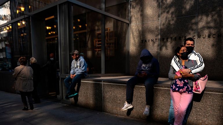 Willan Herrera and Marabel Torres wait outside St. Peter's Church...