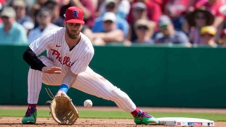 Philadelphia Phillies first baseman Bryce Harper fields the ball during...