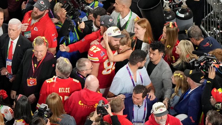 Kansas City Chiefs tight end Travis Kelce (87) hugs his...