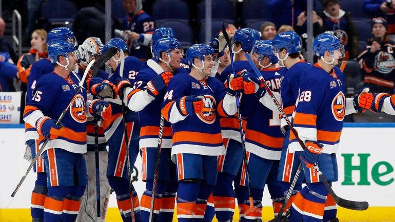 The Islanders celebrate after defeating the New Jersey Devils at UBS...