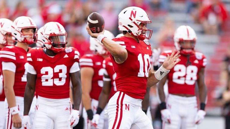 Nebraska quarterback Heinrich Haarberg (10) passes the ball during warmups...