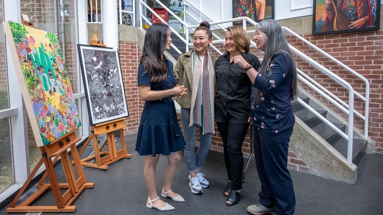 Artist Joan Kim Suzuki, left, Lucie Kwon, board president for the United Asian...