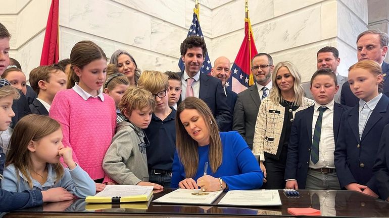 Arkansas Gov. Sarah Huckabee Sanders signs an education overhaul bill...