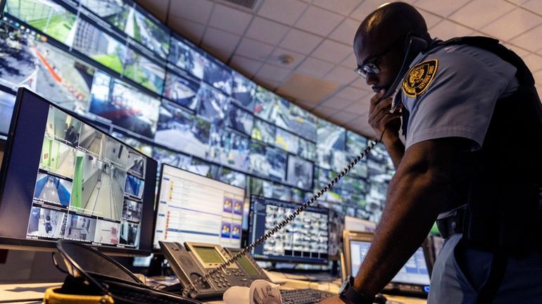 A security officer speaks on the phone inside the United...